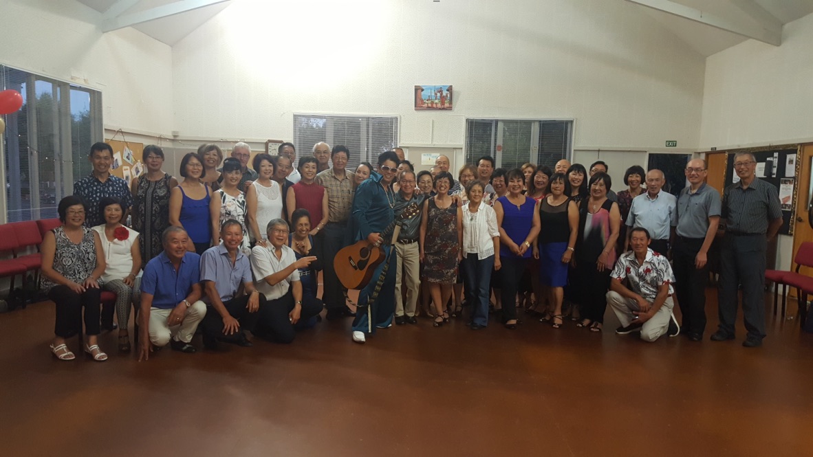 A photo of Jarred Tito singing at a birthday celebration gathering