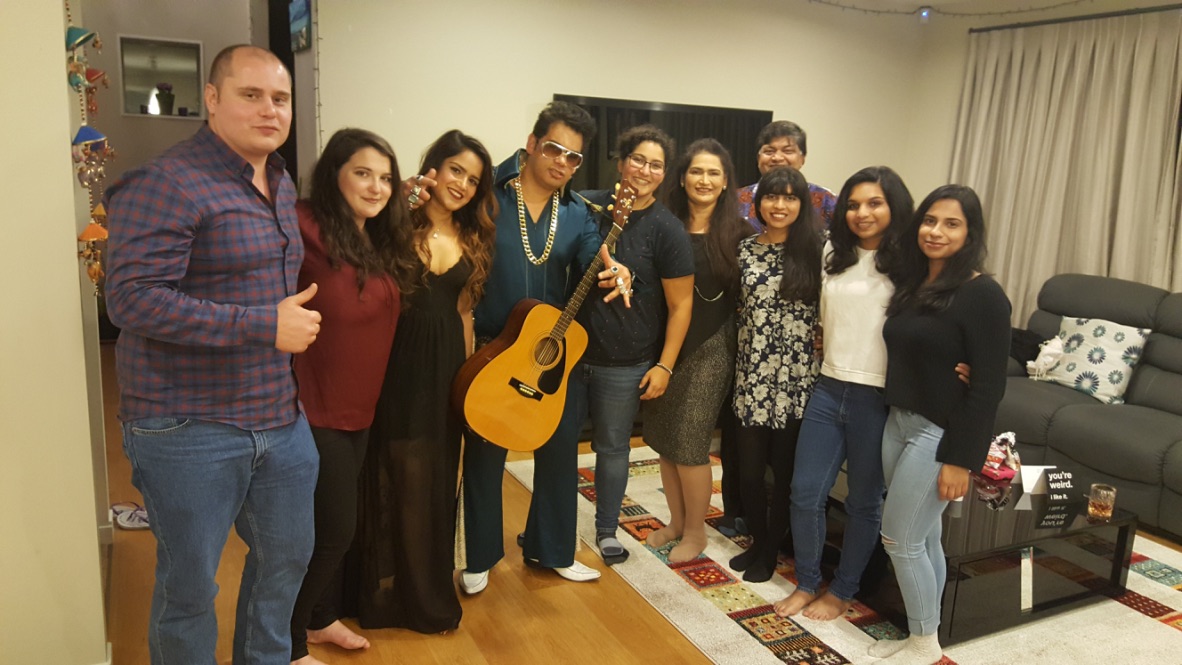 A photo of singer-entertainer Jarred Tito singing at family celebration