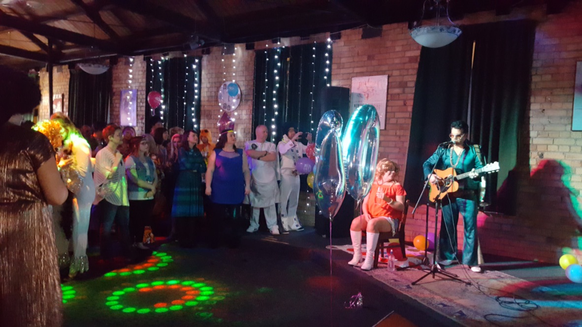 A photo of singer-entertainer Jarred Tito singing at birthday celebration