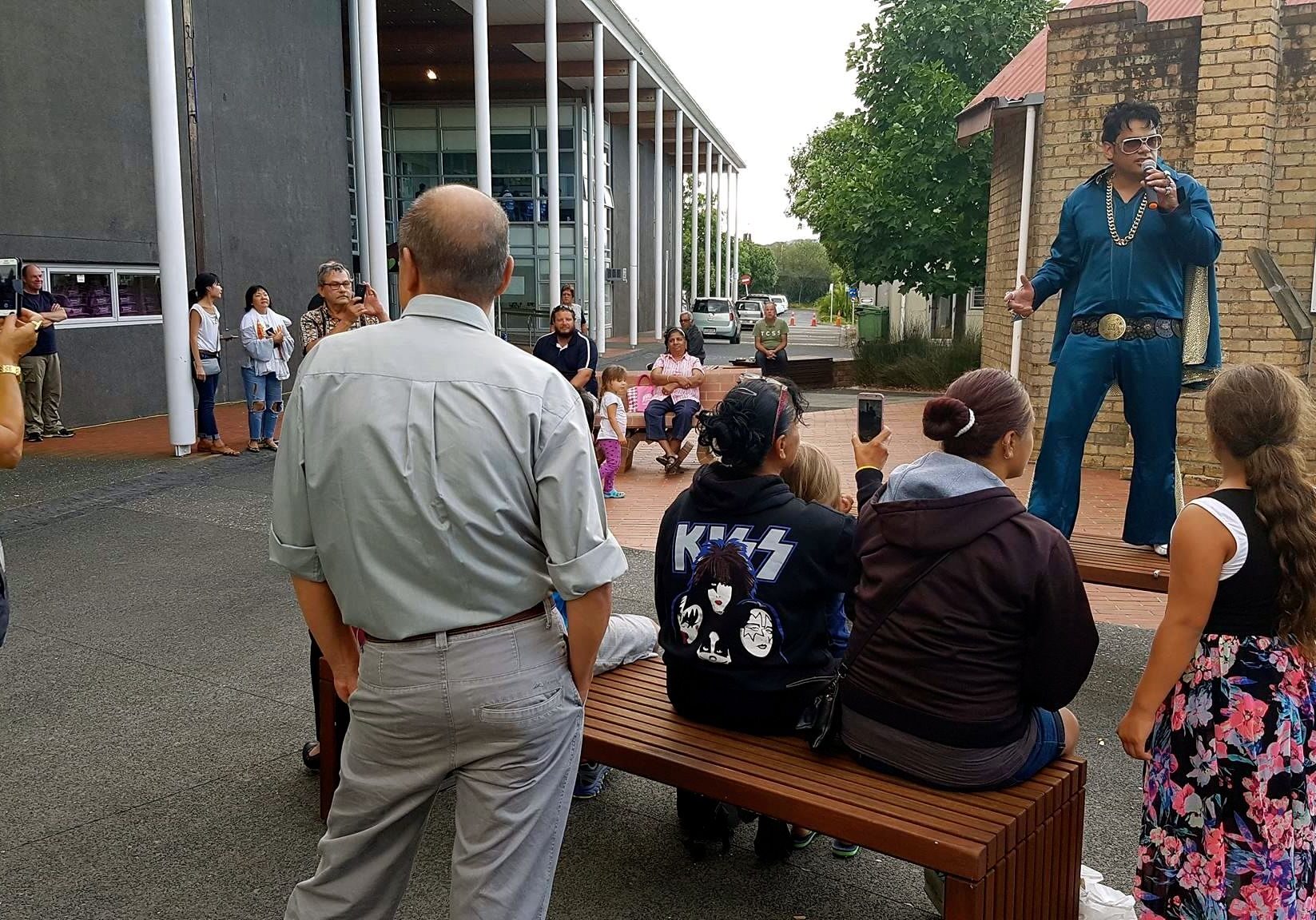 A photo of singer-entertainer Jarred Tito singing as Elvis at Auckland market