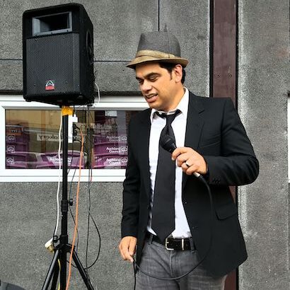 A photo of Jarred Tito performing in the style of Frank Sinatra at Auckland market
