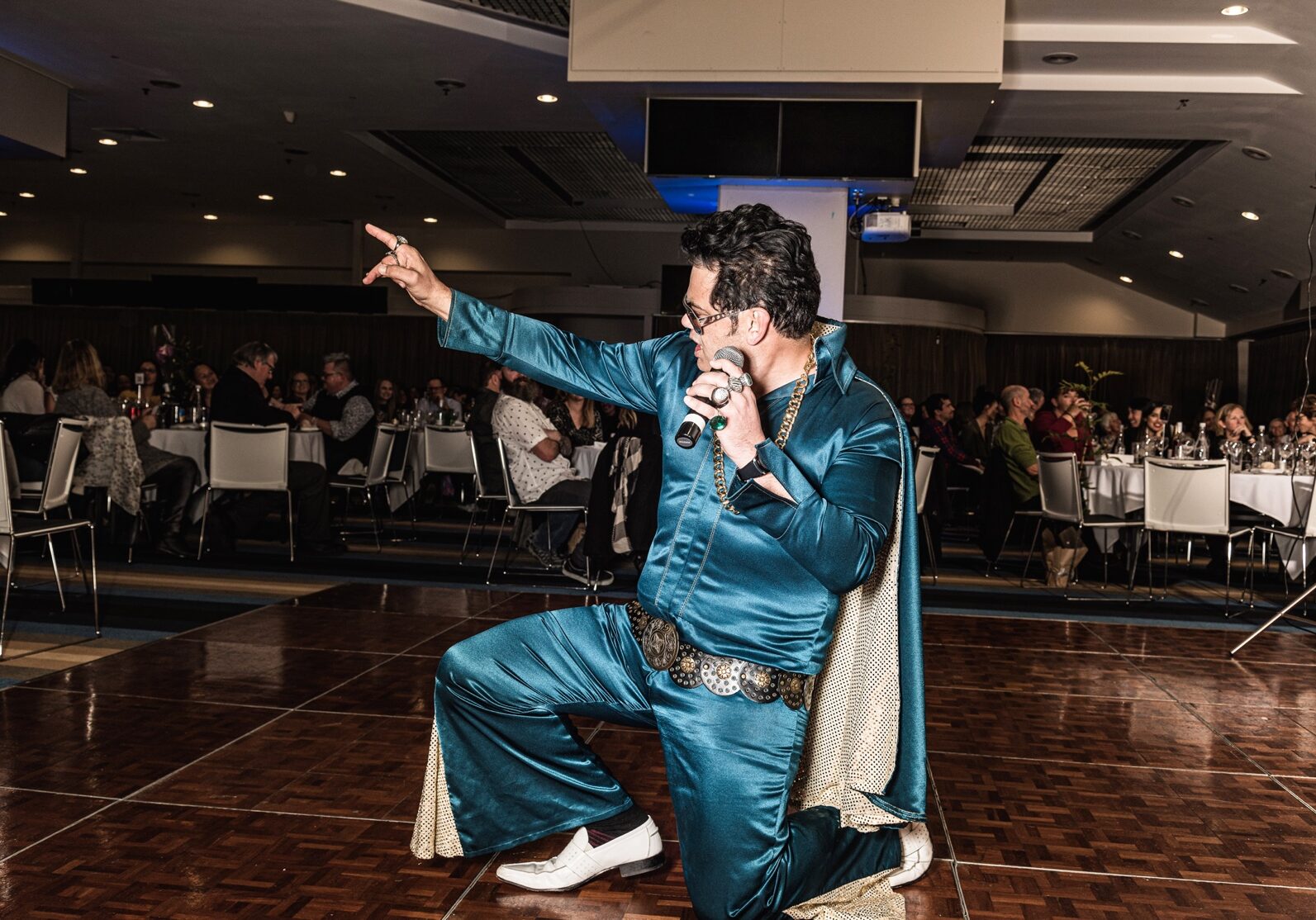 A photo of singer-entertainer Jarred Tito performing at a corporate event